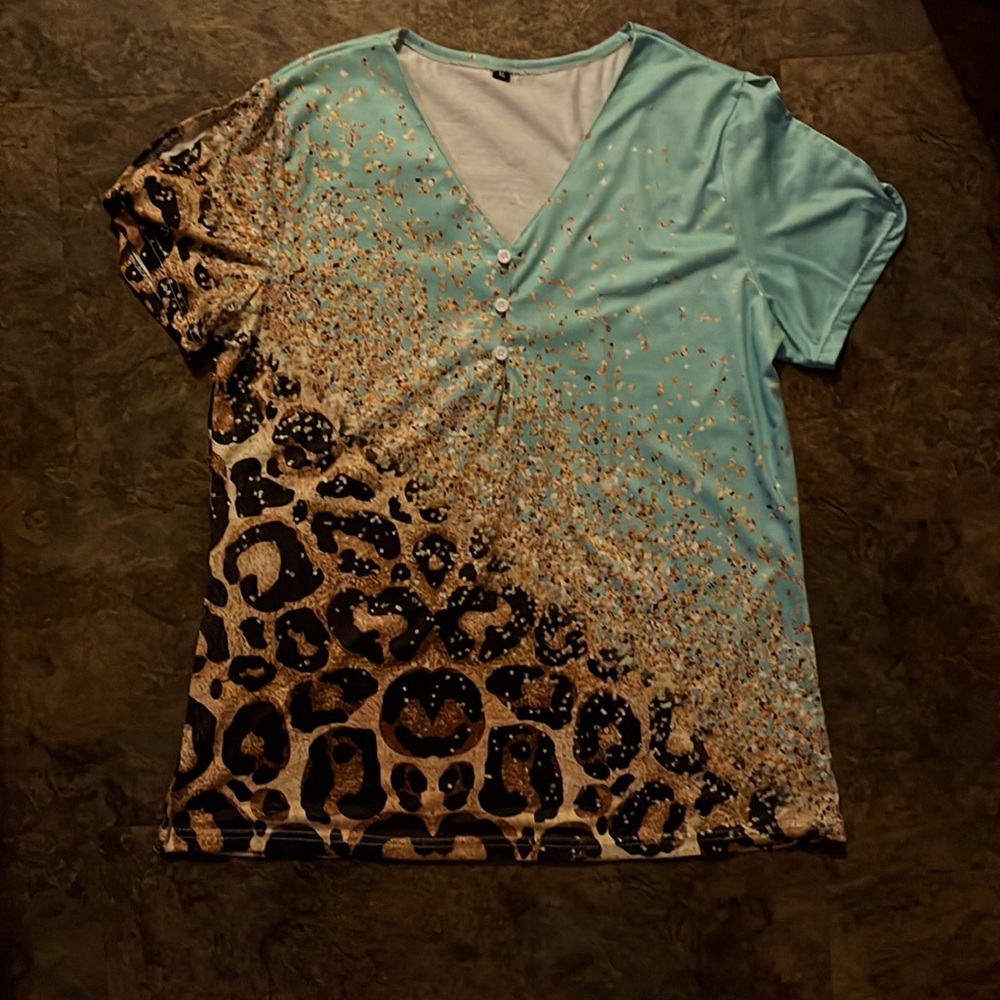 Polyester top with slits on the top of sleeves. Size is XL never worn.
